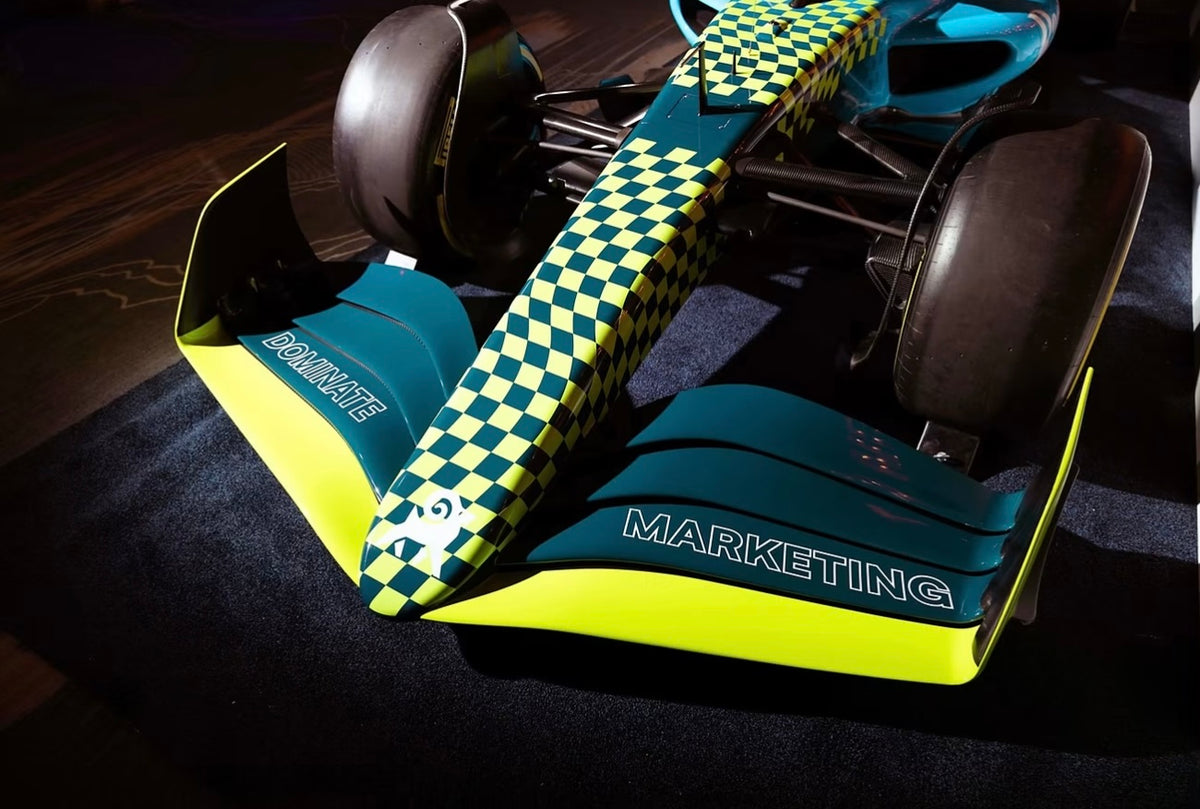 Close-up of a teal and lime custom-wrapped F1 show car nose and front wing