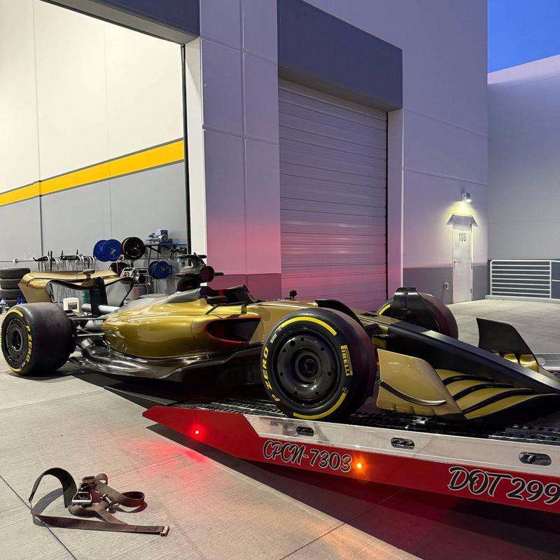 Show car being transported on a trailer